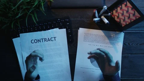 Overhead shot of man having video translation and looking on diagrams and graphs Stock Footage 81183822