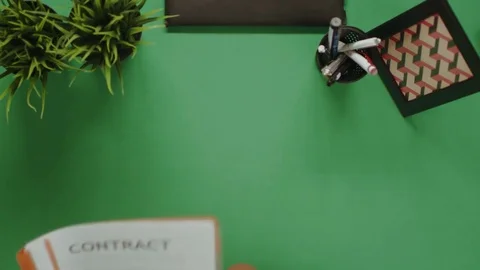 Overhead shot of man reading contract while drinking coffee Stock Footage 81219902