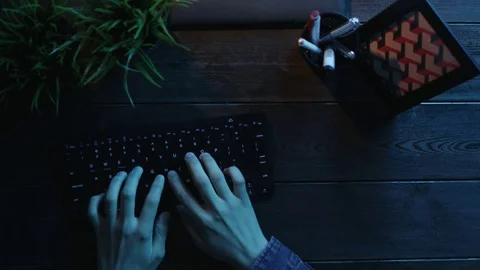Overhead shot of man typing on keyboard and sticking note with word "Done!" on Stock Footage 81198624