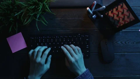 Overhead shot of man typing on keyboard and sticking note with words "Good job Stock Footage 81198992