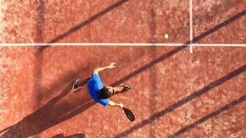 Overhead shot of a man who is playing paddle tennis on an outdoor court. Stock Footage 159193655