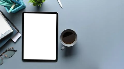 Overhead shot of mock up tablet computer, coffee cup, notebook and stationery Stock Photos