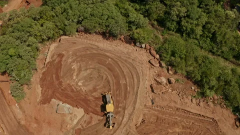 Overhead shot of a motor grader leveling the ground Stock Footage 261049739