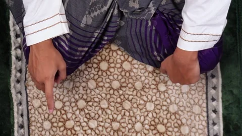 Overhead shot of muslim man doing praying position or salat Stock Footage 268377907
