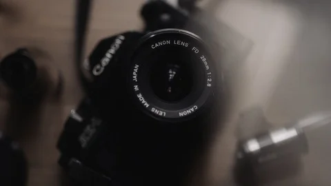 OVERHEAD SHOT OF OLD 35MM CAMERA WITH NATURAL LIGHT AND LENS DISTORTION Stock Footage 92848973