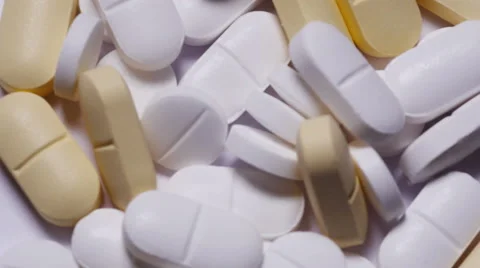 Overhead shot of pills turning Stock Footage 55703370
