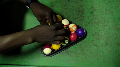 Overhead shot of a player arranging pool balls in the rack Stock Footage 254794266