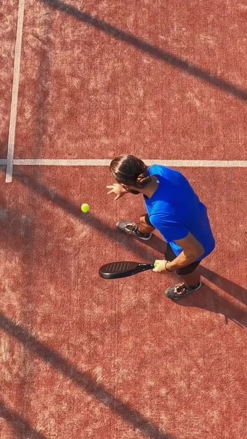 Overhead shot of a professional padel player bounces the ball and takes it out. Stock Footage 310104318