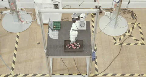 Overhead shot of robotic arm doing repetitive task Stock Footage 121706168