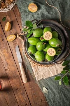 Overhead shot of a rustic still life with ripe pineapple guavas, some cut o.. Stock Photos