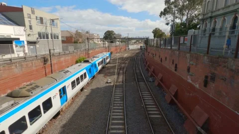 Overhead shot of second Melbourne train moving through left shot, 4K Stock Footage 138685619