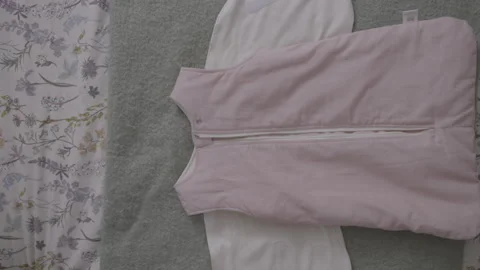 Overhead shot, sequence of garment closed and then carefully opened Stock Footage 344321496