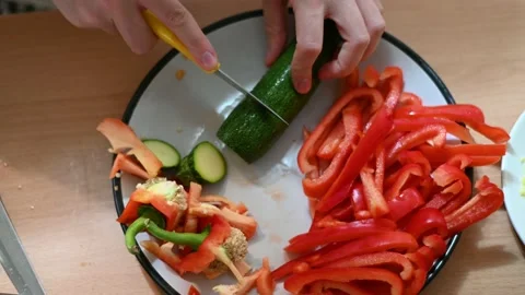 Overhead shot of a sharp knife slicing a courgette Stock Footage 233050763