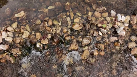 Overhead shot of a small waterfall in a stream with several stones Stock Footage 327907652