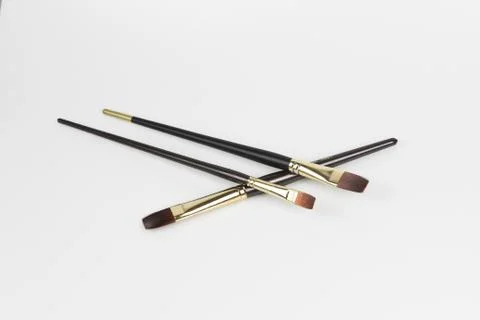 An overhead shot of a three small size flat brush with a white-colored surfac 写真素材