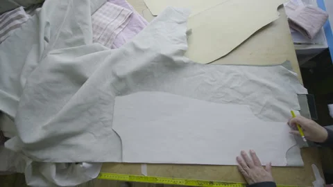 Overhead shot tracing a pattern on fabric on a work table Video stock 344322018