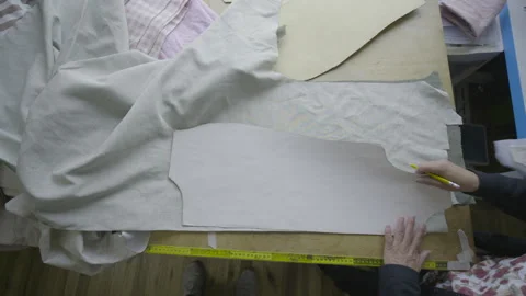 Overhead shot, tracing a pattern on fabric spread out on a work table Video stock 344322985