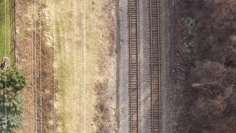 Overhead Shot of Train Engine Entering Frame from above in Aerial Drone Shot Stock Footage 124906730