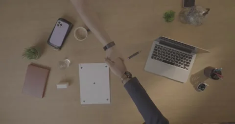 Overhead shot of two people shaking hands for a deal. 스톡 동영상 330155933