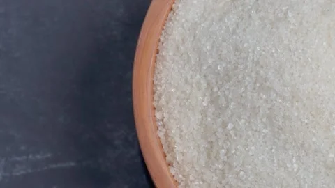 Overhead shot view of half a spinning wooden bowl of sugar Stock Footage 281062602