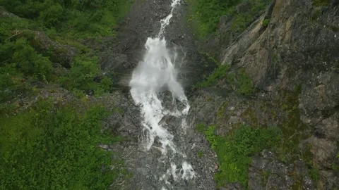 Overhead shot of waterfall going over the cliff showing crashing water below Stock Footage 247003636