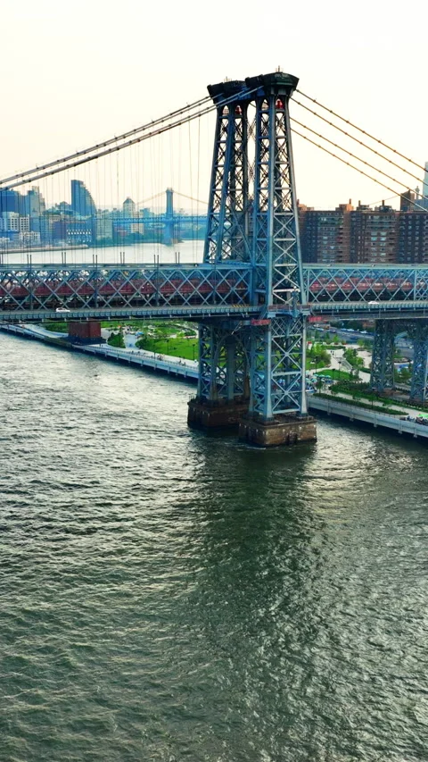 Overhead shot of Williamsburg bridge tower over East River, New York Vertical Stock Footage 342273560