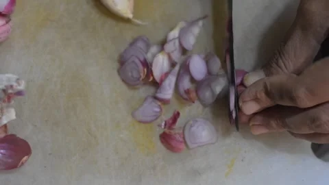 An overhead shot of a woman's hand cutting an onion Stock Footage 287997153