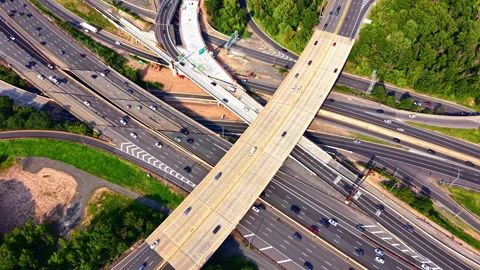 Overhead shot of X shaped overpass crossing multilane freeway Видео 341033752
