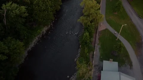 Overhead showcasing a creek, green trees, and a park with a baseball field Stock Footage 247428376