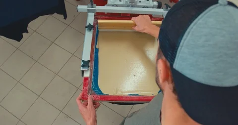 OVERHEAD Silk screen printing process - preparing rotating screen Stock Footage