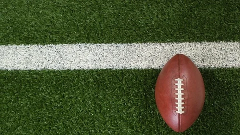 Overhead slider of a yard line and an American football Stock Footage 116003264