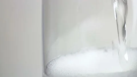 Overhead Slow motion Close up of Champagne bubbling in a Goblet Stock Footage 235832084