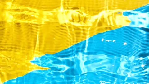 Overhead slow motion video of vibrant yellow blue liquid texture with shimmering Stock Footage 343004866