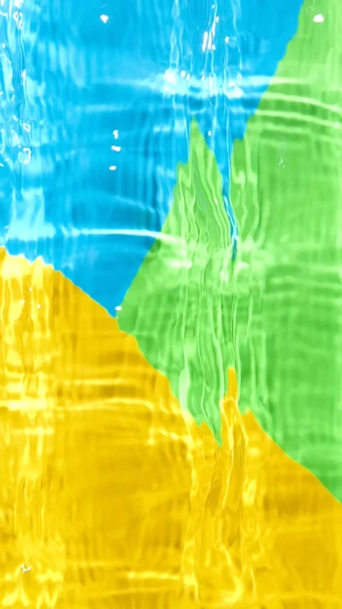Overhead slow motion video of vibrant yellow blue and green liquid texture with  Stock Footage 343005010