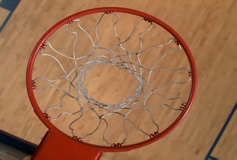 Overhead slow-motion view through basketball hoop: ball going in Stock Footage 86918751