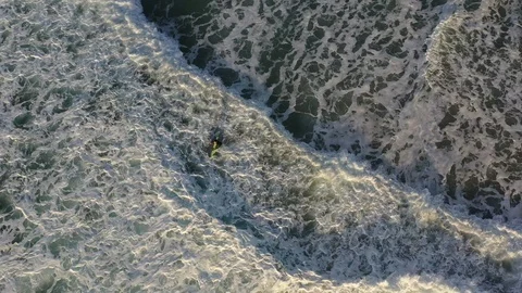 Overhead of Surfer in the Waves Stock Footage 124498191