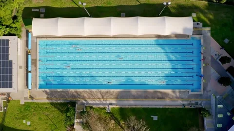 Overhead top down aerial shot of an outdoor olympic size, six lane, pool Stock Footage 133560465