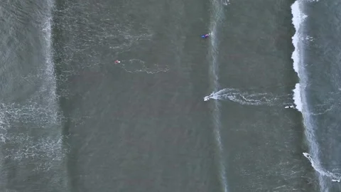 Overhead Top Down Aerial Of Surfers Paddling Over Glassy Ocean Swell Lines Stock Footage 342651538