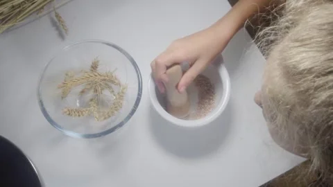 Overhead Top Down Close Up Shot of Student Grinding Wheat Flour in Mortar for Stock Footage 342094076