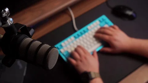 Overhead top-down shot of a microphone in focus at a PC setup while the Stock Footage 327556914