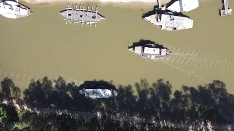 Overhead top down view of old steam powered boats running tourists along the  Stock Footage 155178156