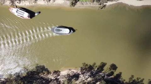 Overhead top down view of old steam powered boats running tourists along the  Stock Footage 155178157