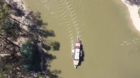 Overhead top down view of old steam powered boats running tourists along the  Stock Footage 155178164