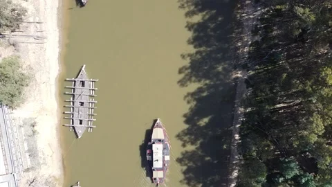 Overhead top down view of old steam powered boats running tourists along the  Stock Footage 155178166