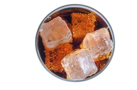 Overhead top view of cola drink with floating ice cubes and bubbles Stock Photos