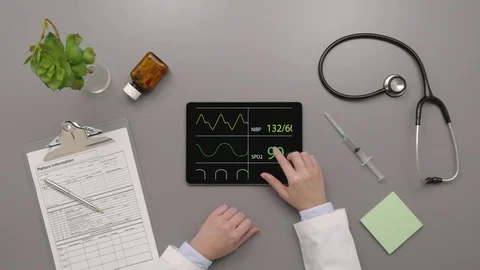 Overhead Top View Of Doctor Examining Pulse Trace On Digital Tablet Stock Footage 79649340