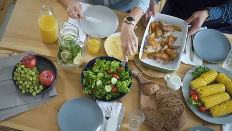 Overhead top view of table. four caucasian friends taking meals and eating lunch Video stock 119921601
