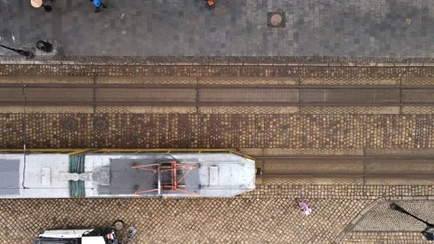 Overhead top view of tram going pass city street Stock Footage 149623422