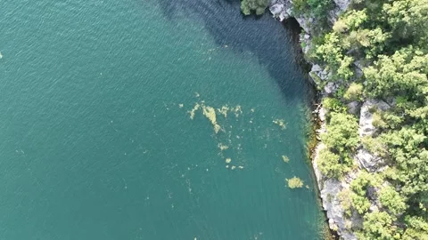 Overhead tracking shot along river and cliffs 스톡 동영상 253660707
