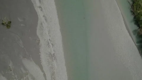 Overhead tracking shot of braided river near Kokatahi, New Zealand. Drone 4K Stock Footage 240515849